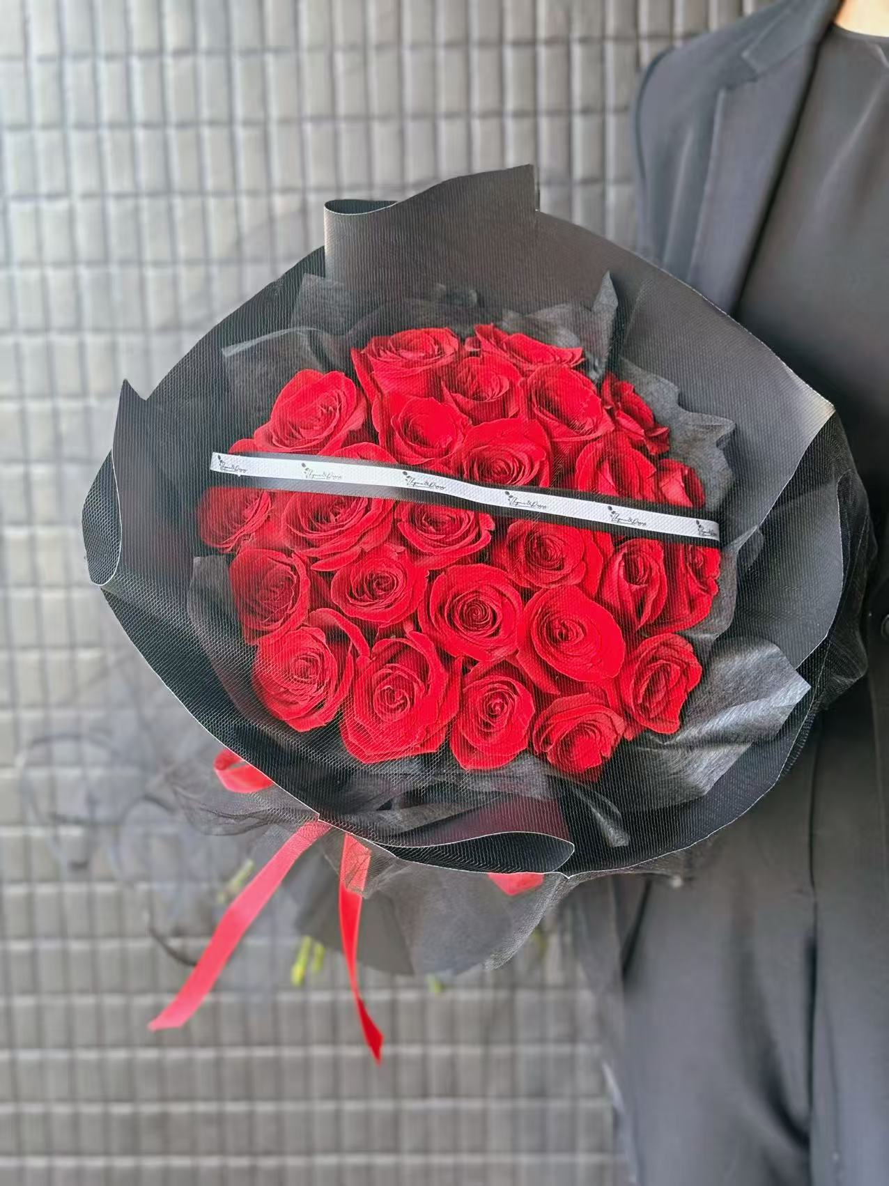 24 red roses bouquet with black mesh wrapping