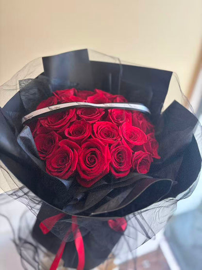 24 red roses bouquet with black mesh wrapping
