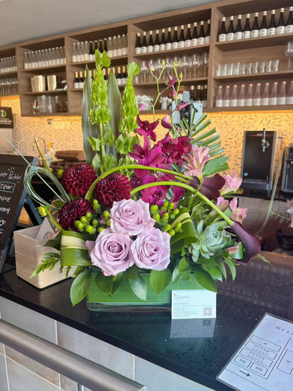 Purple front desk floral arrangement