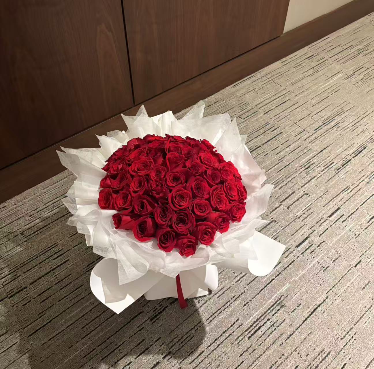 Pure Passion-33 red roses with white wrapping bouquet