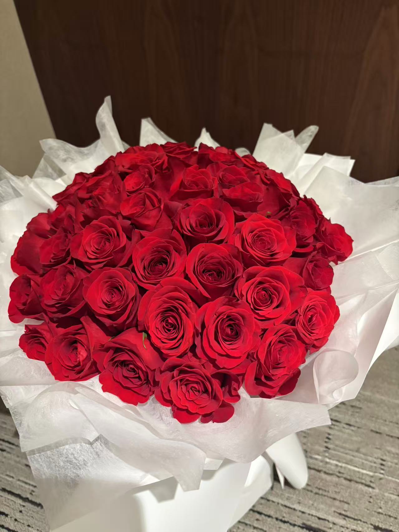 Pure Passion-33 red roses with white wrapping bouquet