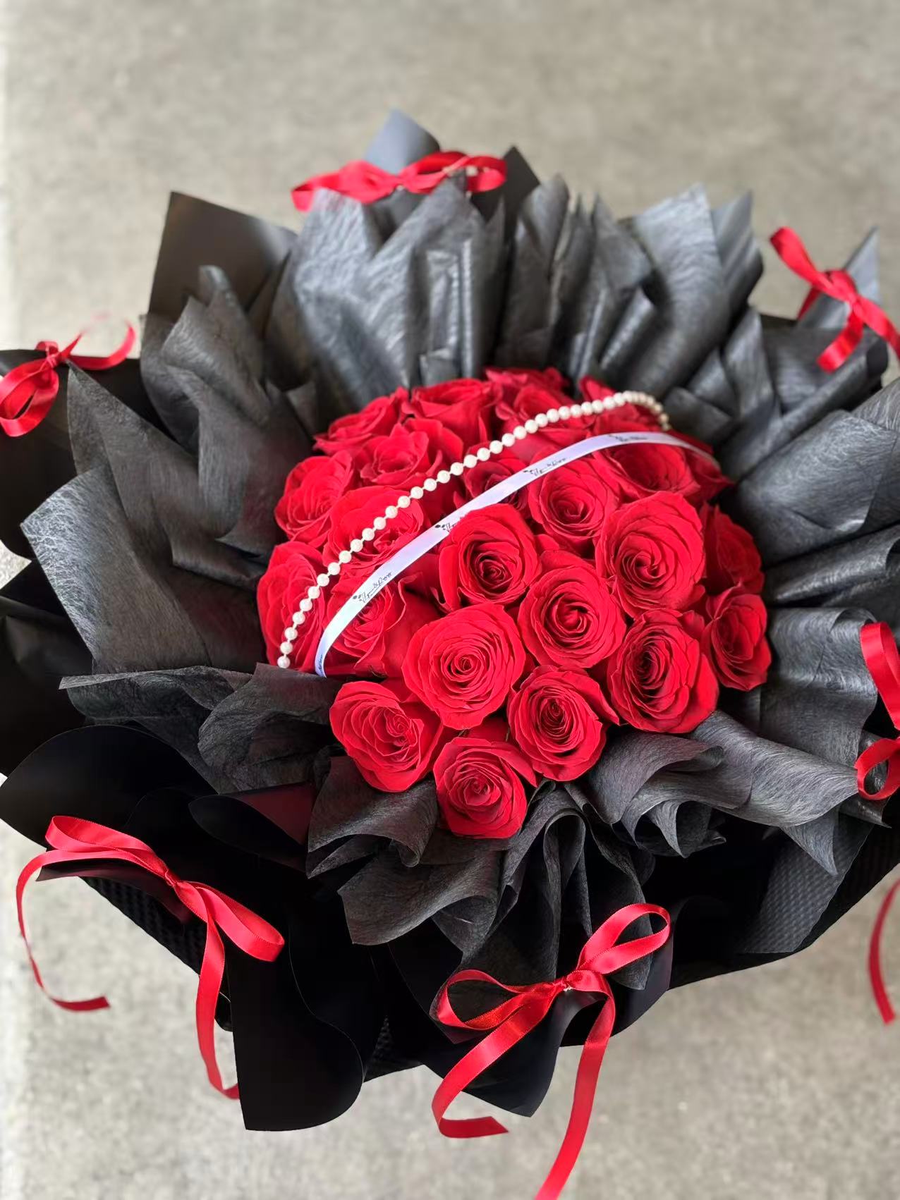 Timeless Love-24 red roses with black wrapping bouquet