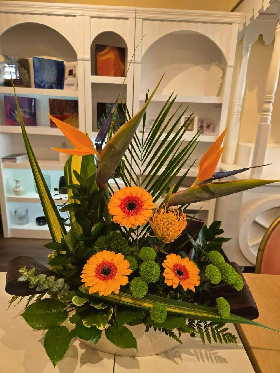 Orange reception desk floral arrangement