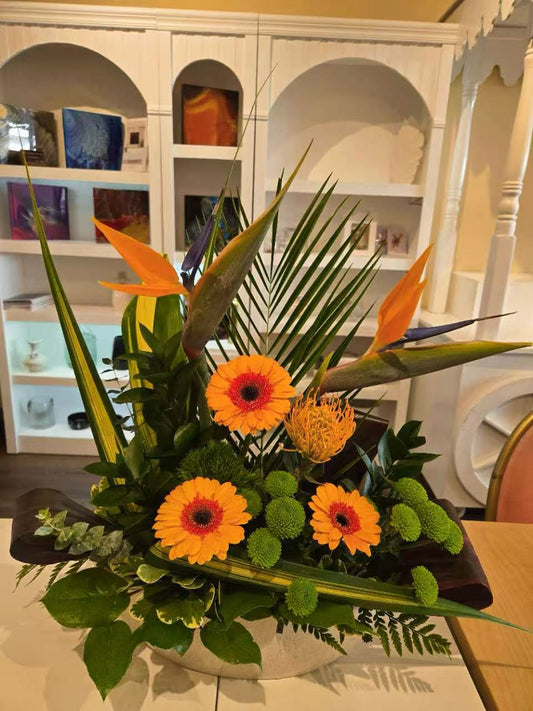 Orange reception desk floral arrangement